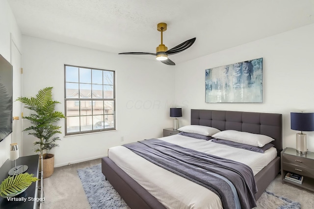 bedroom with light colored carpet, a textured ceiling, and ceiling fan