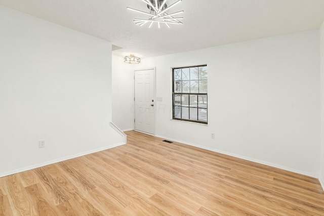 unfurnished room featuring light hardwood / wood-style flooring