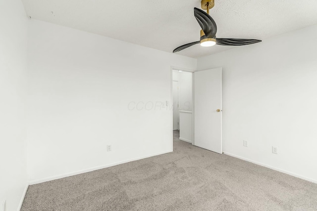 carpeted spare room with a textured ceiling