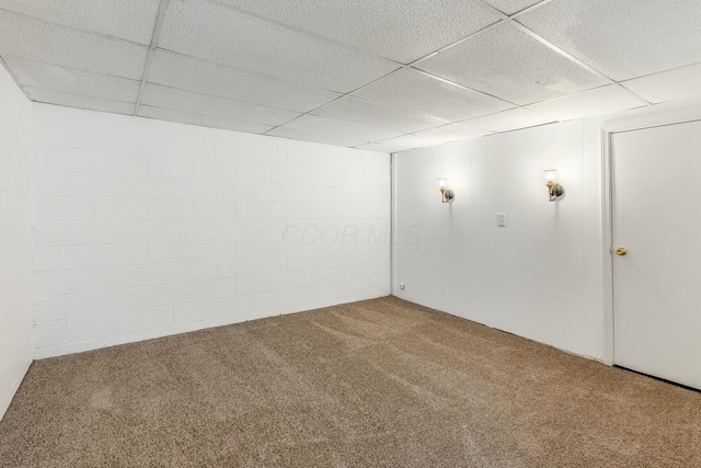 basement with carpet flooring and a paneled ceiling