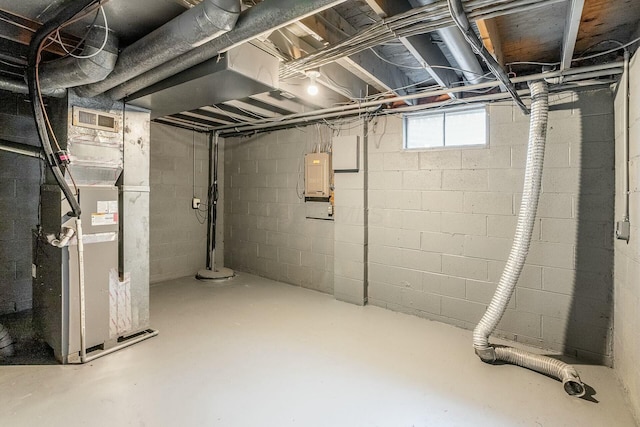 basement featuring electric panel and heating unit