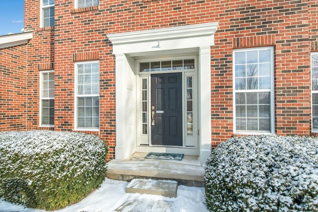 view of snow covered property entrance