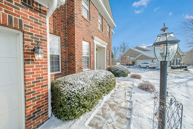 snow covered property featuring a garage