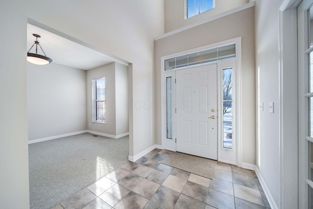 view of carpeted entrance foyer