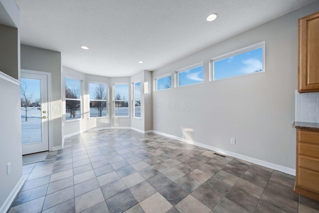 unfurnished living room with a textured ceiling