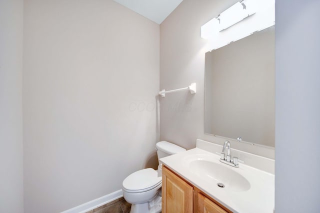 bathroom featuring tile patterned floors, vanity, and toilet