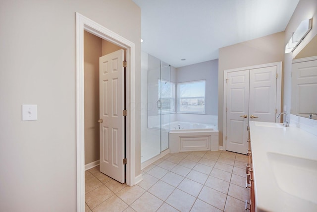 bathroom featuring tile patterned flooring, vanity, and plus walk in shower