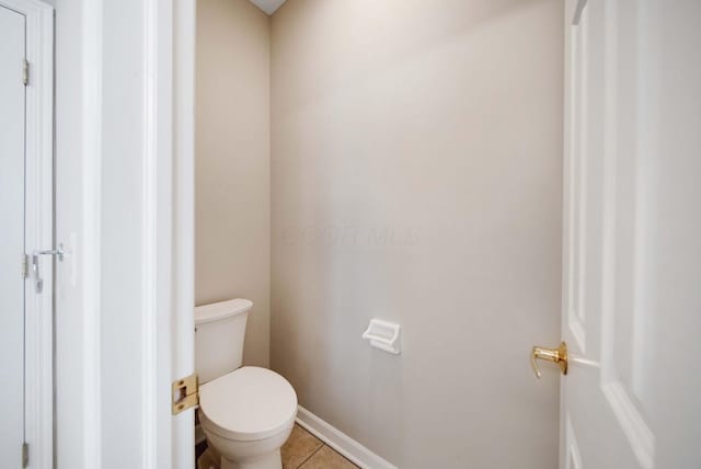 bathroom with tile patterned flooring and toilet