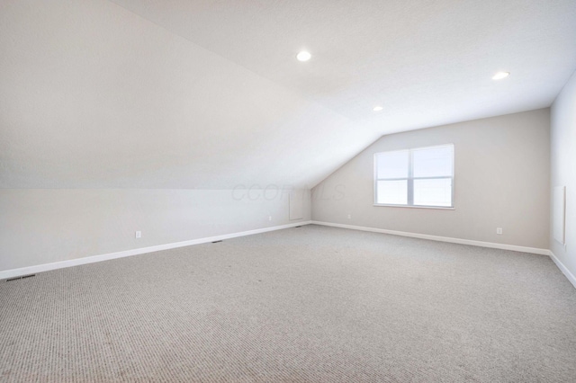 bonus room featuring lofted ceiling and carpet