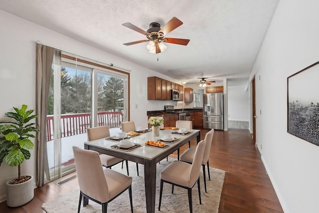 dining space with dark hardwood / wood-style flooring, ceiling fan, and a textured ceiling