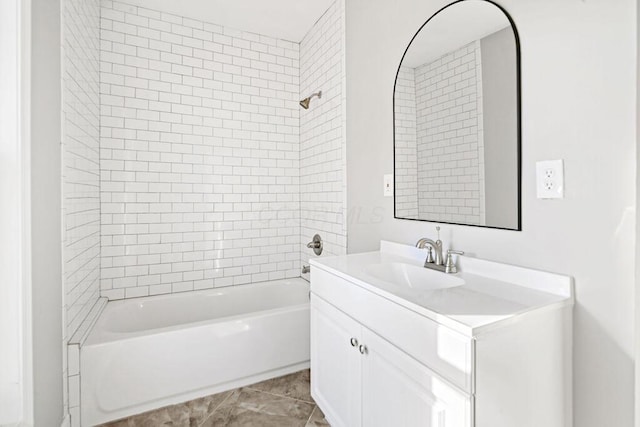 bathroom featuring tile patterned floors, vanity, and tiled shower / bath combo