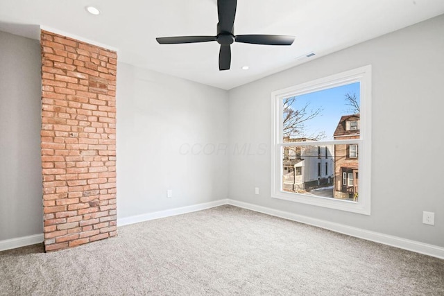 spare room with carpet and ceiling fan