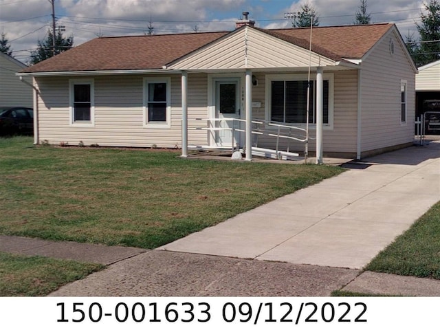 view of front facade with a front yard and covered porch