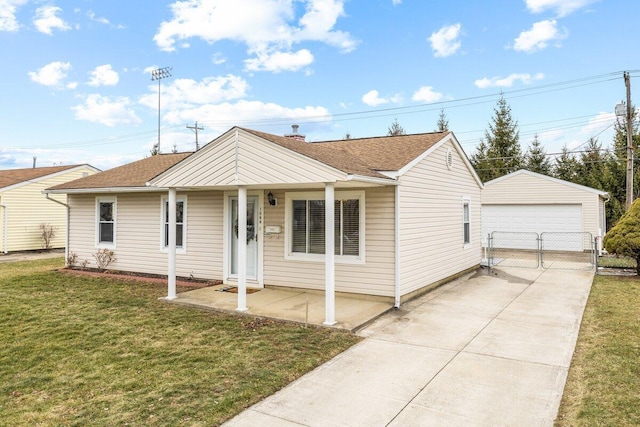 view of front of property with a garage, an outdoor structure, and a front lawn