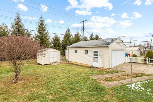 exterior space with a garage, a yard, and a storage unit