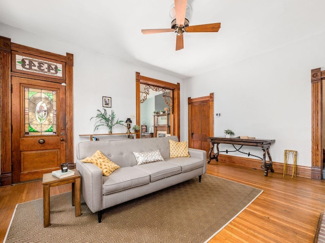 living room featuring hardwood / wood-style flooring and ceiling fan