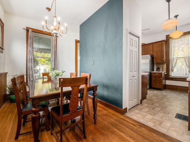 dining space featuring a notable chandelier