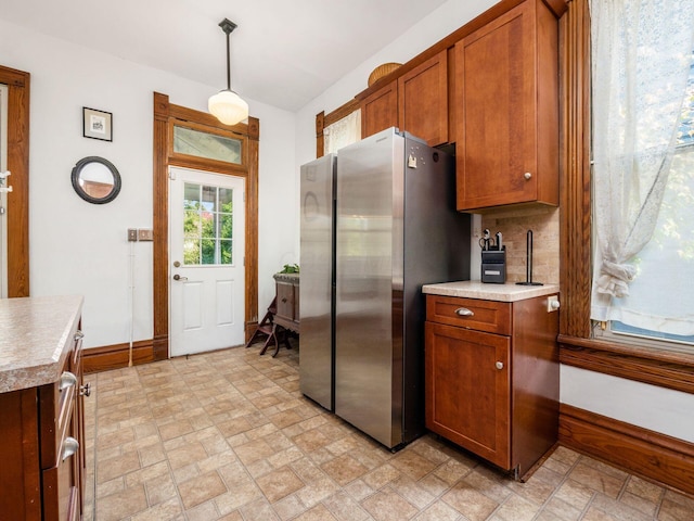 kitchen with pendant lighting and stainless steel refrigerator