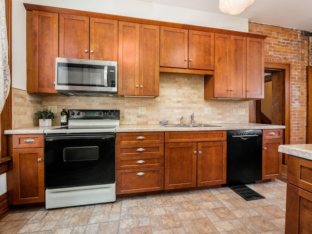 kitchen with sink, dishwasher, range with electric cooktop, brick wall, and decorative backsplash