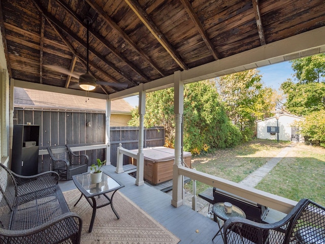 view of patio featuring a storage unit and a deck