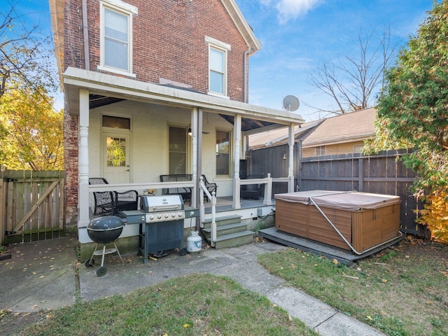 rear view of house with a hot tub