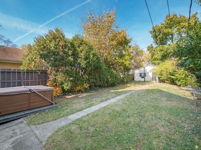 view of yard with an outbuilding and a hot tub