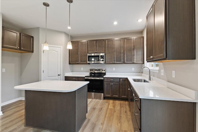 1208 Heathgate Way, Fairborn, OH 45324 - kitchen with stainless steel appliances, a sink, light wood-style floors, dark brown cabinets, and recessed lighting