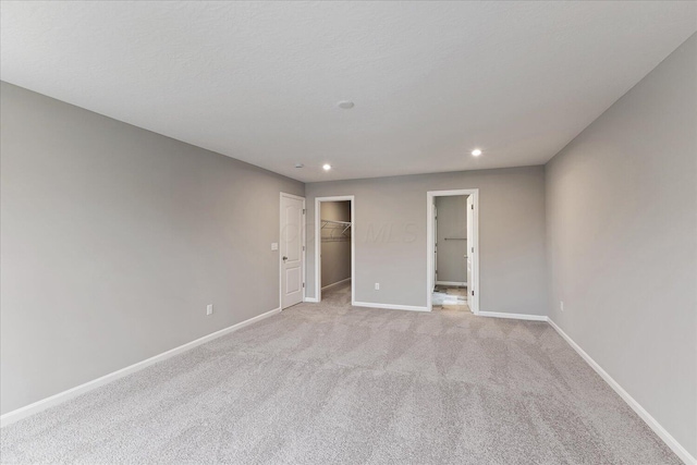 1208 Heathgate Way, Fairborn, OH 45324 - unfurnished bedroom with recessed lighting, baseboards, light colored carpet, and a spacious closet
