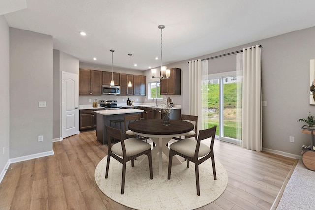 1208 Heathgate Way, Fairborn, OH 45324 - dining room with light wood-type flooring, recessed lighting, baseboards, and a chandelier
