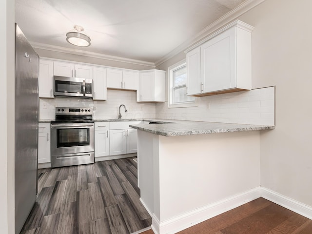 kitchen with white cabinetry, light stone counters, kitchen peninsula, stainless steel appliances, and dark wood-type flooring