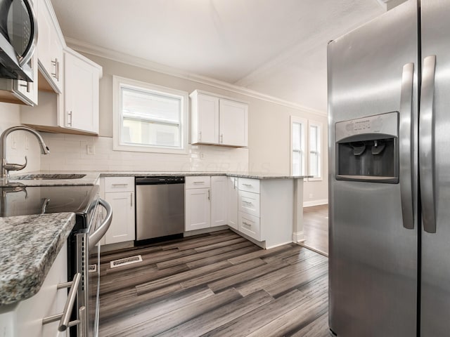 kitchen featuring white cabinetry, tasteful backsplash, light stone counters, dark hardwood / wood-style floors, and stainless steel appliances