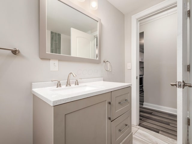 bathroom with vanity and hardwood / wood-style floors