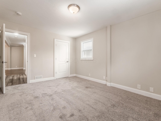 unfurnished bedroom with carpet flooring and a closet