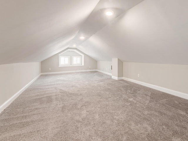 additional living space with lofted ceiling and carpet floors