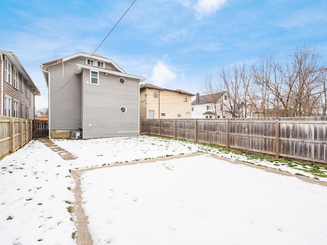 view of snow covered back of property