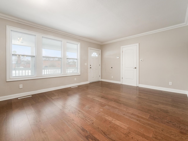 interior space with dark hardwood / wood-style flooring and ornamental molding