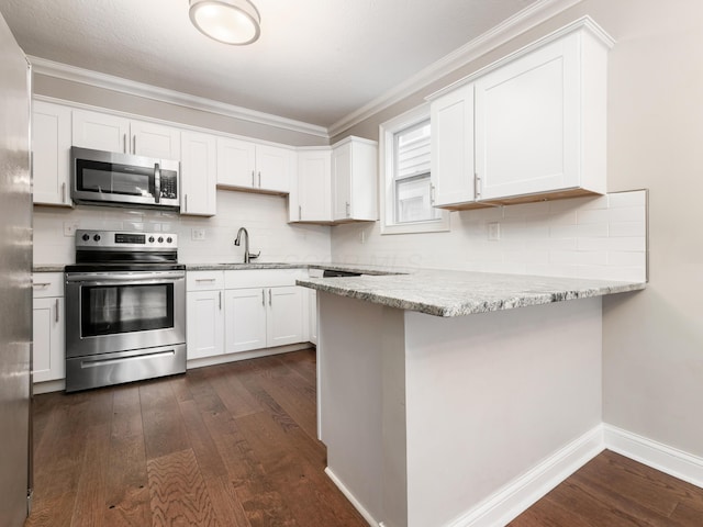 kitchen featuring appliances with stainless steel finishes, white cabinetry, sink, dark hardwood / wood-style flooring, and light stone countertops