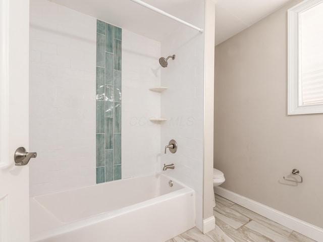 bathroom with bathtub / shower combination and toilet