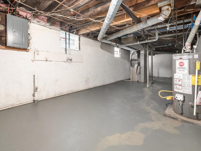 basement featuring water heater and electric panel