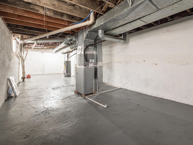 basement featuring heating unit and gas water heater