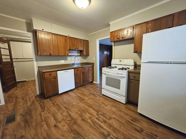 kitchen with sink, white appliances, ornamental molding, and dark hardwood / wood-style floors