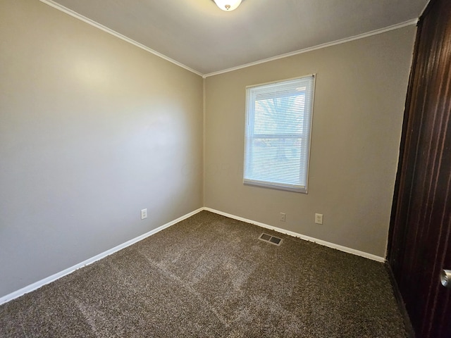 spare room featuring crown molding and carpet floors