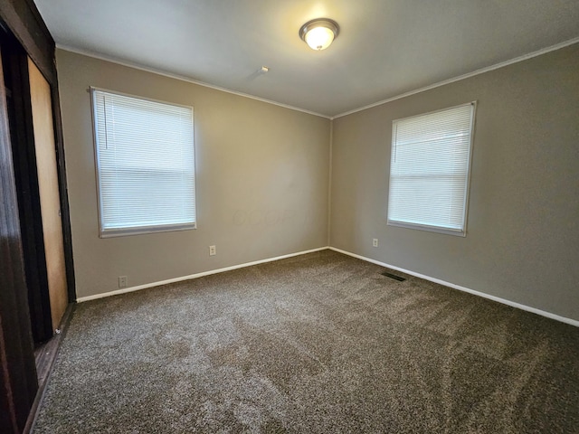 carpeted spare room with crown molding