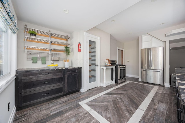 bar featuring dark hardwood / wood-style flooring and appliances with stainless steel finishes