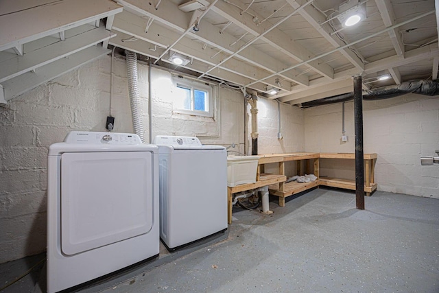 washroom with separate washer and dryer and sink