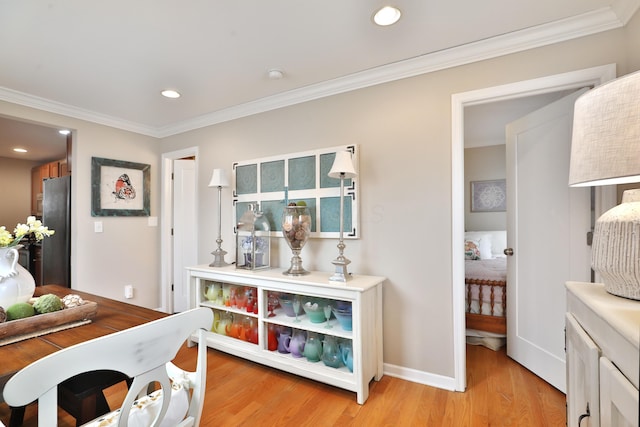 interior space featuring crown molding and light hardwood / wood-style floors