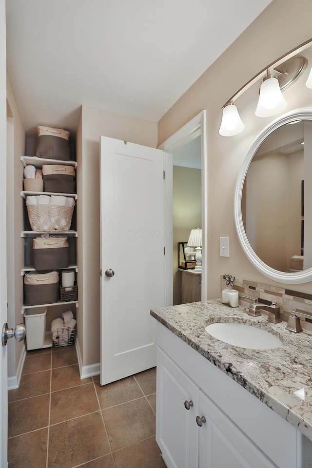 bathroom with vanity, tile patterned flooring, and decorative backsplash