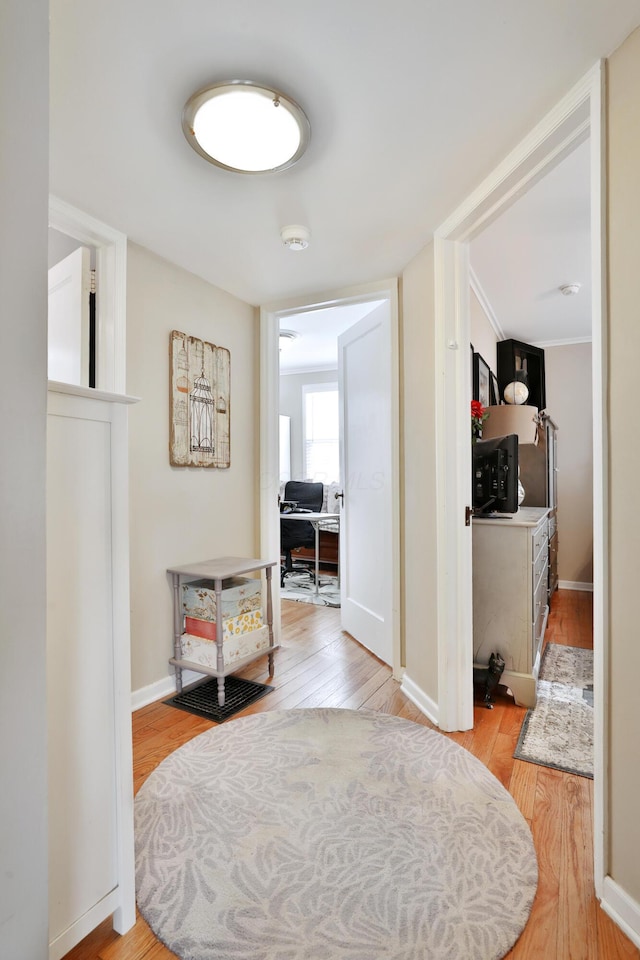 corridor with light hardwood / wood-style floors