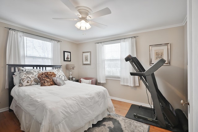 bedroom featuring multiple windows, wood-type flooring, and ceiling fan