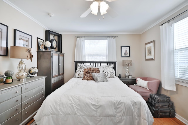 bedroom featuring multiple windows, crown molding, light hardwood / wood-style flooring, and ceiling fan